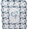Quilted white blanket with blue ring pattern and a heart motif