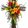 A bright, devotional cross crafted on a tall twig framework, this funeral