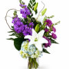 Large white lilies rise above a lush cloud of pale blue and