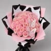 Pink rose bouquet wrapped in pink and black paper with butterfly decorations