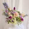 A soft, elegant mix of blush roses, lavender blooms, creamy hydrangea, and
