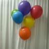 6 bright, glossy balloons filled with helium and tied onto a balloon