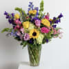 All the bright colors in a tall clear vase. Filled with a