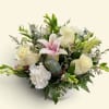 Bouquet of white roses, pink lilies, and white carnations in a vase