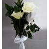 Three white roses in a clear glass vase with a white ribbon