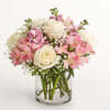 Pink and white bouquet of roses and alstroemeria in a clear glass vase