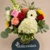Mixed bouquet of roses, gerbera daisies, and hydrangea in a glass vase