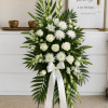 Elegant white standing funeral spray with fresh roses, gladiolus, and chrysanthemums. A