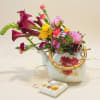 Deep magenta calla lilies arching over sunny yellow blooms make a bold