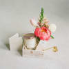 Gift basket with flowers, a candle, and a thank-you card