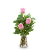 Pink roses arranged in a clear glass vase with variegated greenery