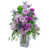 Lavender roses and purple flowers in a clear glass vase