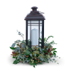 Black lantern with a white candle and greenery base