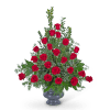 Red roses arranged in a gray vase with greenery