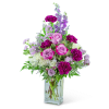 Pink and purple flower arrangement in a clear glass vase
