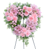 Heart-shaped pink floral wreath on a stand