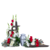 Red roses and white flowers arranged around a silver urn and wooden cross