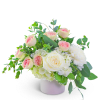 Pink and white roses in a white vase with greenery