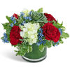 Red roses and white flowers in a glass vase with a succulent accent