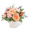 Pink and peach roses in a white vase