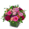 Pink and lavender roses with carnations in a square glass vase