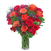 Mixed bouquet of red and orange roses in a clear glass vase