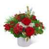 Red roses and red flowers in a white vase with pine and berries