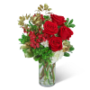 Red roses and red alstroemeria in a clear glass vase