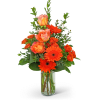 Orange roses and gerbera daisies in a clear glass vase