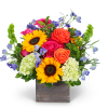 Bright mixed bouquet in a square wooden vase with sunflowers and roses