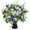 White and blue floral arrangement in a cobalt glass vase
