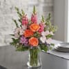 (ONE-SIDED) Orange roses with pink snapdragons, pale alstroemeria and lavender chrysanthemum in