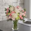 Blush pink and ivory roses with pale alstroemeria, carnations and chrysanthemums in