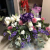 Large purple, white, and pink floral arrangement with a Happy Mother's Day sign