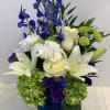 Blue and white floral arrangement in a cobalt vase