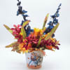 Colorful floral arrangement in a decorated ceramic pot