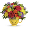 Colorful bouquet in a yellow smiley-face mug