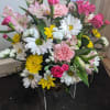Mixed flower basket with daisies, carnations, roses, and a butterfly decoration