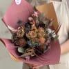 Muted tan and dusty pink dried blooms arranged with deep purple and