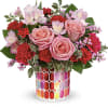 Pink roses and red carnations in a colorful mosaic vase