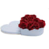 Red roses in a light blue heart-shaped box with a lid beside it