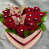 A luxurious heart-shaped box filled with 14 rich red roses, golden butterfly
