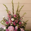 Pink and white floral arrangement in a white vase