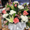 Bouquet of pink roses, white lilies, and white chrysanthemums with a white ribbon