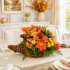 Autumn floral centerpiece in a wicker basket on a dining table