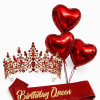 Red heart balloons with a jeweled crown and a Birthday Queen sash