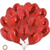 Cluster of red heart-shaped balloons with strings attached