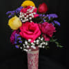 Mixed roses with baby's breath in a pink vase