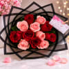 Bouquet of red and pink roses wrapped in black paper