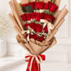 Bouquet of red roses wrapped in tan paper with ribbon